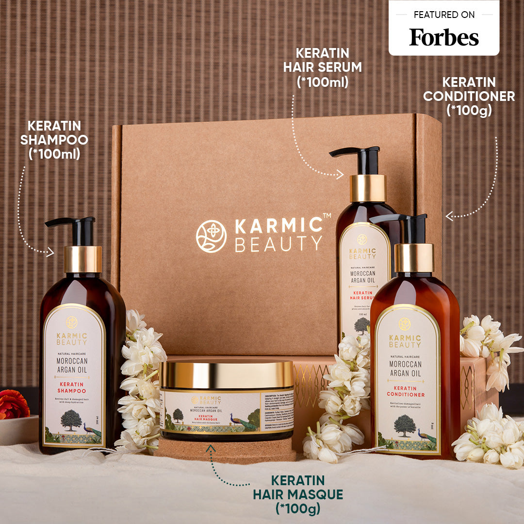 Karmic Beauty Moroccan Argan Oil hair care product set with shampoo, serum, conditioner, masque, on a brown background.