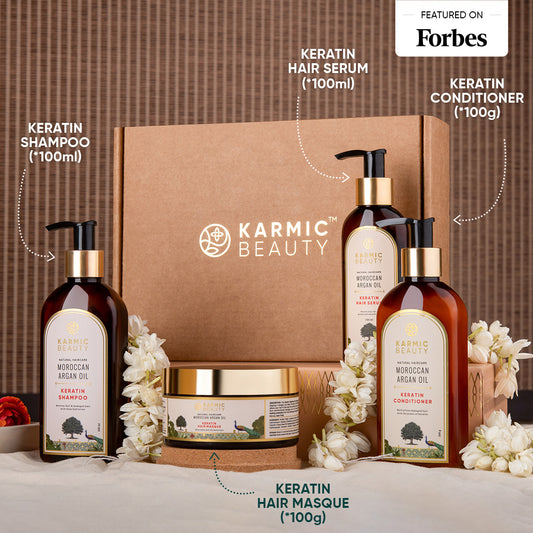Karmic Beauty Moroccan Argan Oil  hair care product set with shampoo, serum, conditioner, masque, on a brown background.
