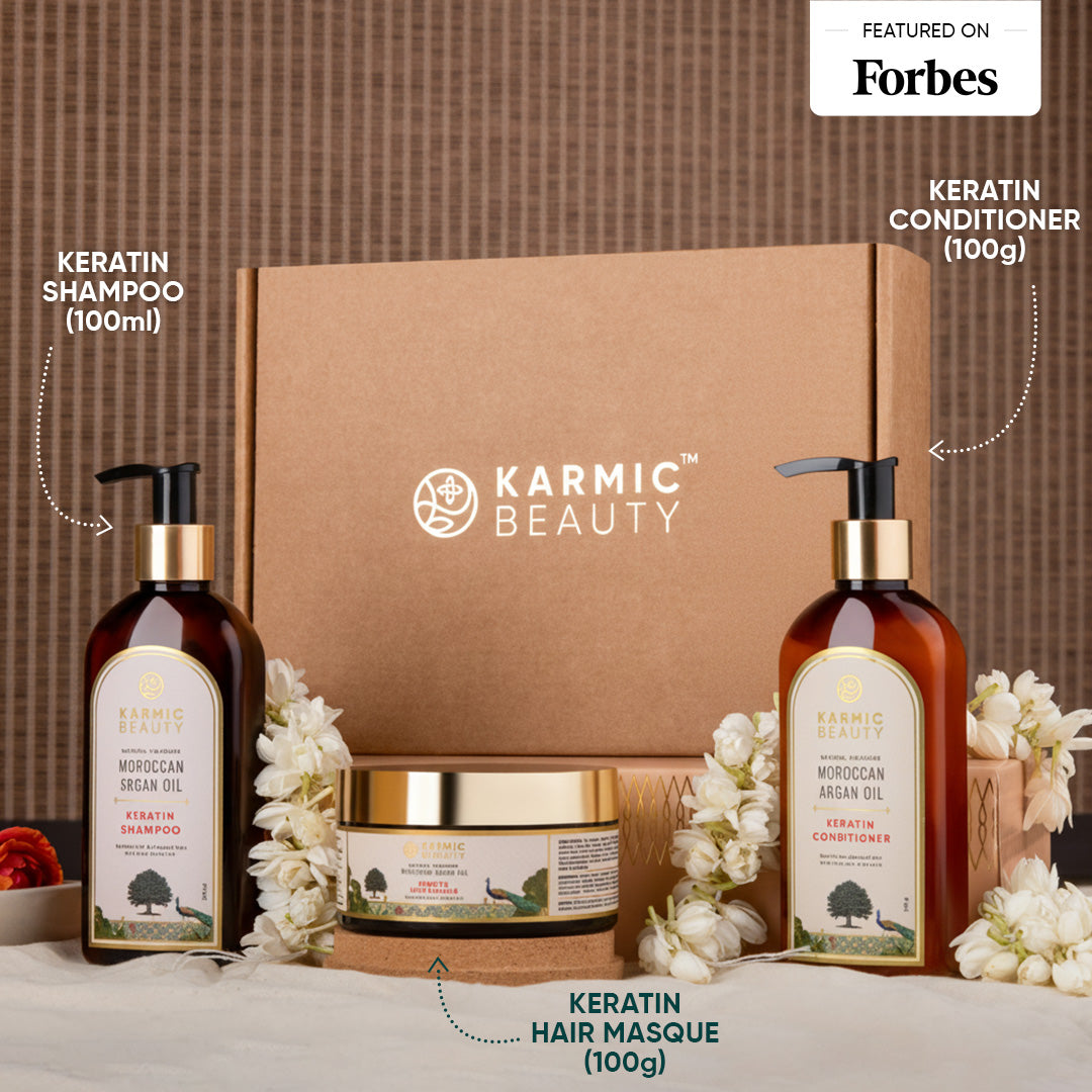 Karmic Beauty hair care product set with shampoo, conditioner, and masque on a textured surface.