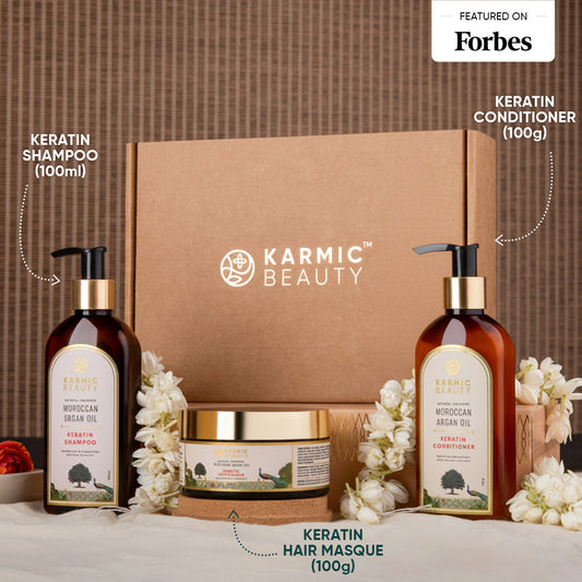 Karmic Beauty hair care product set with shampoo, conditioner, and masque on a textured surface.