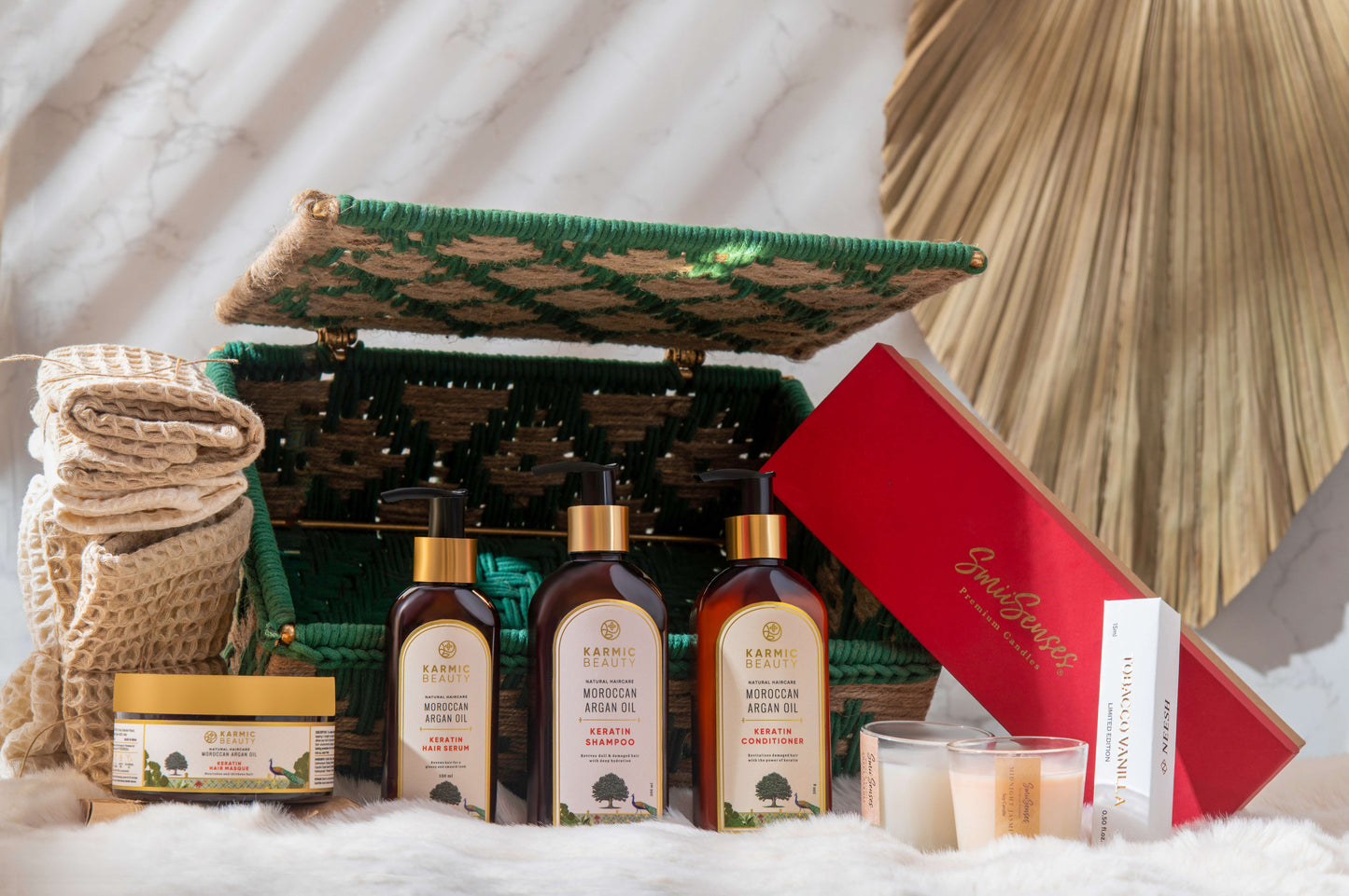 Luxurious gift hamper with premium self-care essentials, including hair care, perfume, towels, and candles, in a handmade basket